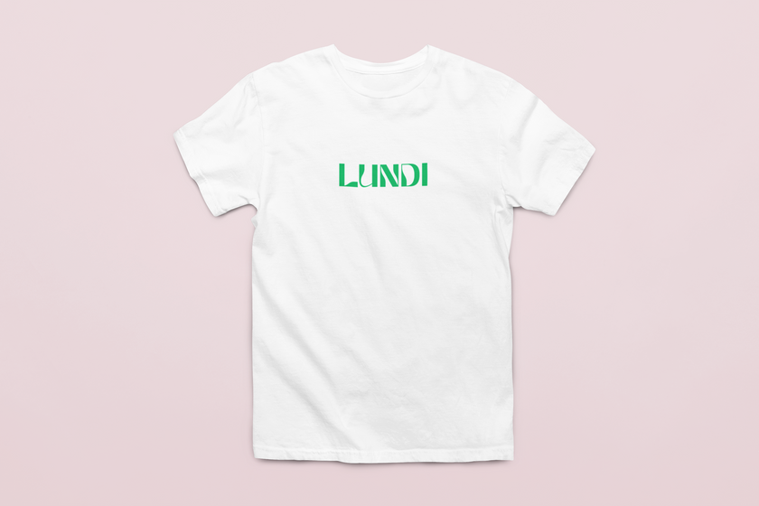 White unisex t-shirt with black “LUNDI” text, minimalist French design worn casually.