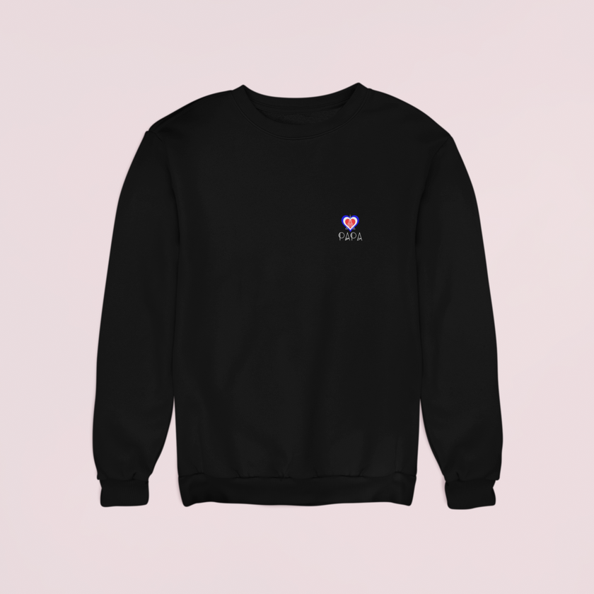 Model wearing KOULEURS men’s black sweatshirt with Eiffel Tower and pink “Papa” lettering, designed for Father's Day.