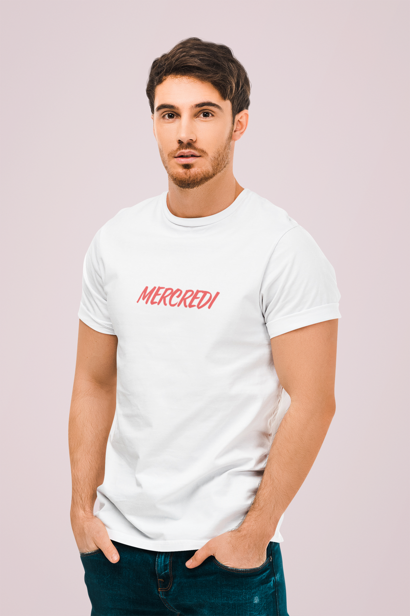 Model wearing KOULEURS MERCREDI white unisex cotton t-shirt with red embroidered French lettering.
