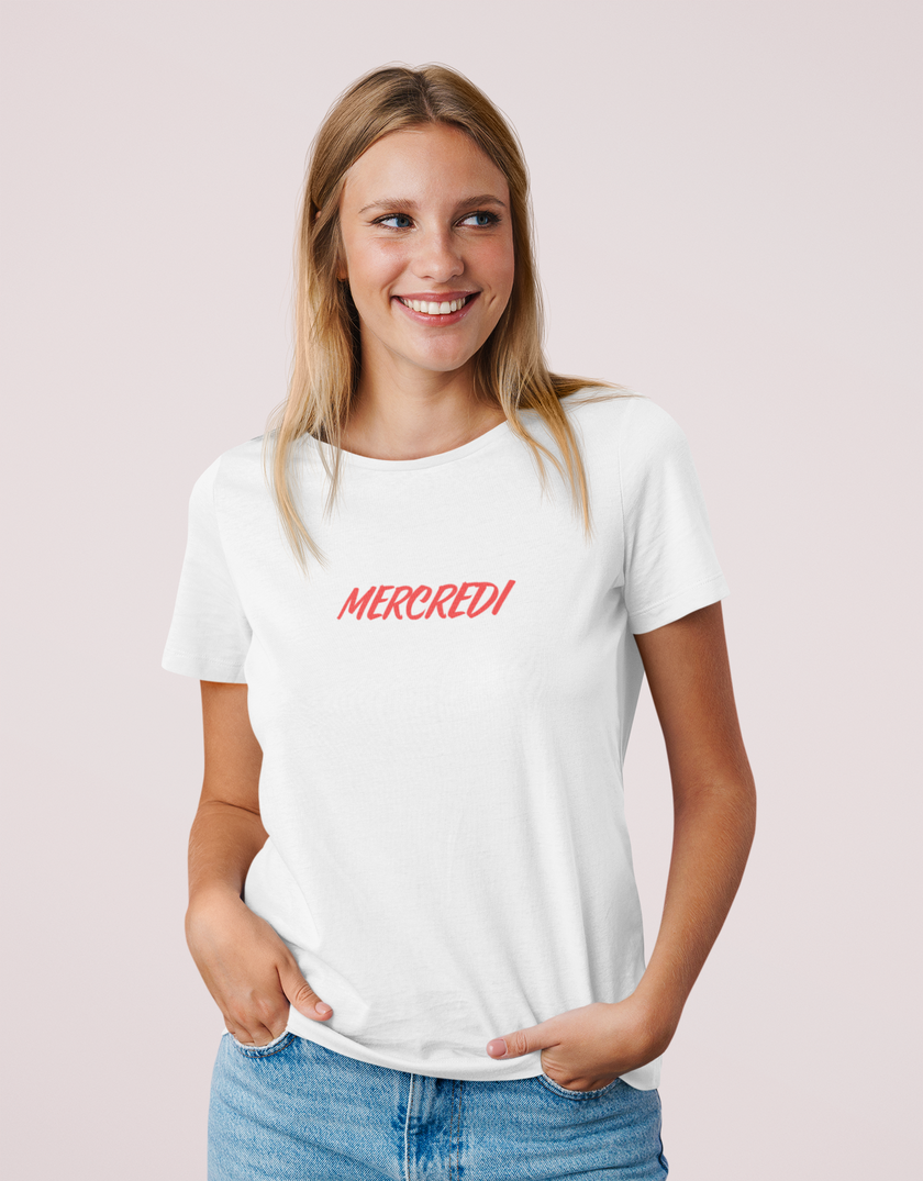 Model wearing KOULEURS MERCREDI white unisex cotton t-shirt with red embroidered French lettering.
